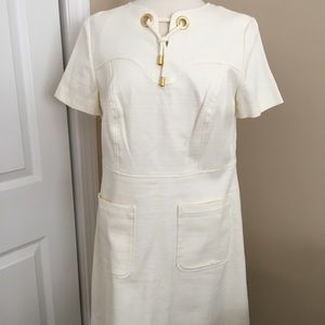 White lined dress with chunky gold accent